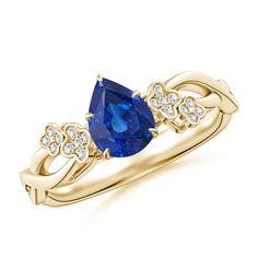 a yellow gold ring with an oval blue sapphire and diamonds