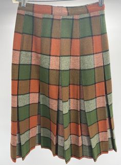 Vintage 100% Wool Plaid Pleated Skirt W/Union Tag Green/Orange  This vintage wool skirt comes in good used condition, with little signs of use and wear. This skirt does not have a size tag and measure approximately 11.5" across the waist, 26" from top to bottom. Please see photos as they are part of the description and exact condition details. Thank you for looking. Retro Green Skirt For Fall, Fall Multicolor Skirt, Multicolor Fall Skirt, Multicolor Skirt For Workwear In Fall, Fitted Multicolor Skirt For Fall, Fall Multicolor Pleated Skirt, Multicolor Pleated Skirt For Fall, Vintage Multicolor Skirt For Fall, Fitted Orange Bottoms For Winter