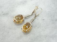 These are some of our finest citrine gems, shaded like a sunset, with glowing amber depths. The bars in the center are textured rose gold, originally links from an antique pocket watch chain. At the very top are the earring wires, 14k yellow gold with a simple polished design. These are comfortable to wear and very secure! Metal: 14K Yellow, Rose and White Gold Stone: 2 Citrines, 15.16 carat total. 12 x 16mm Oval Earring Length: 44 mm Earring Width: 12 mm Luxury Amber Citrine Earrings, Antique Pocket Watch, Pocket Watch Antique, Citrine Earrings, Earring Wires, Pocket Watch Chain, Oval Earring, Watch Chain, Gold Stone