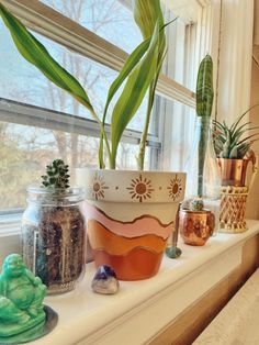 some plants are sitting on a window sill