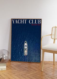 the yacht club poster is next to a chair