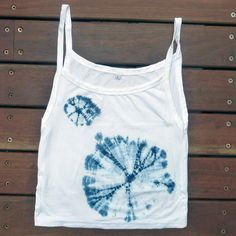 Slim, cropped tank top perfect for layering with a V-neck, scoop back style in a slim fit. The knit of these make them a little stretchy, but they are quite small in size. Made from organic combed cotton in Indonesia then shibori dyed in natural indigo right here in our backyard in Australia. Kids seem to love these tank tops. We tie and then dye and rinse each dress individually. Every dress is a one-of-a-kind, the nature of the shibori process means it is impossible to make exact copies. Natur Summer Cotton Tie Dye Crop Top, Summer Acid Wash Cotton Crop Top, Bleached Sleeveless Summer Tops, Tie Dye Long Skirt, Shibori Dye, Shibori Tie Dye, Indigo Shibori, Tie Dye Cotton, Tie Dye Tank Top