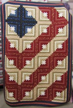 a red, white and blue quilt on display