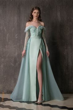 This stunning Chrystelle Atallah Muse M02 Aqua dress is made of luxurious crepe silk, with a crin and tulle couture overskirt. It's adorned with beautiful encrusted chantilly lace, beads and embellishments on the bodice and sleeves. The organza silk material work on the neckline and shoulders adds an elegant touch. The skirt has a slit for added style, and the belt detail completes the look. Guphsey Dresses Fancy, Luxury A-line Silhouette Dresses For Prom, Luxury Elegant Dresses For Cosplay Events, Luxury Floor-length Costume Evening Dress, Luxury Full-length Formal Dress, Luxury Formal Full Length Dresses, Luxury Floor-length Dresses For Festivals, Long Sleeve Wedding Dress Mer, Artemis Prom Dress