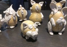 five ceramic figurines of mice on a table