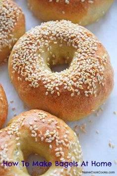 bagels with sesame seeds are on a white surface