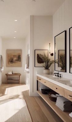 a large bathroom with two sinks and mirrors