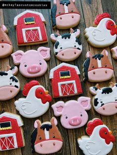 decorated cookies with farm animals and barnyards are on a wooden table, ready to be eaten