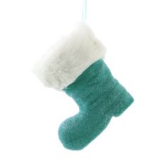 a green stocking hanging from a string with a white fur ball on it's end