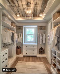 a walk in closet with white cabinets and drawers