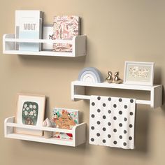 two white shelves with pictures and cards on them