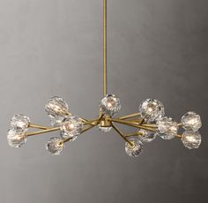 a brass chandelier with clear glass balls hanging from it's center point