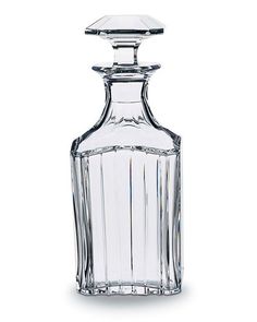 an empty glass bottle with a stopper on the top is sitting in front of a white background