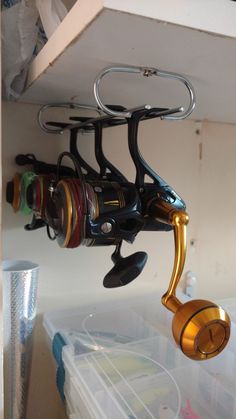 there is a fishing rod and two reels hanging from the ceiling