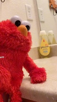 a red stuffed animal sitting on top of a counter