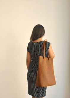 "This tote bag is made of high quality vegan leather in brown. It is soft and lightweight but durable. It has a rustic, distressed look. It has two interior pockets. It has a slouchy silhouette and plenty of room for your daily needs. Measurements: 41 x 31 x 14 cm IMPORTANT! Your orders between 7-25 August will be shipped on August 28. Delivery takes 2-5 days to the US, Canada, Australia and Europe; in 3-7 days to rest of the world after shipping. For other color options you can check \"Totes\" Brown Textured Leather Shoulder Bag For Daily Use, Minimalist Brown Shoulder Bag For Travel, Versatile Everyday Brown Bag, Versatile Brown Satchel For Everyday, Minimalist Brown Soft Leather Shoulder Bag, Everyday Soft Leather Brown Shoulder Bag, Versatile Brown Shoulder Bag, Everyday Brown Soft Leather Shoulder Bag, Minimalist Brown Bags For Daily Use