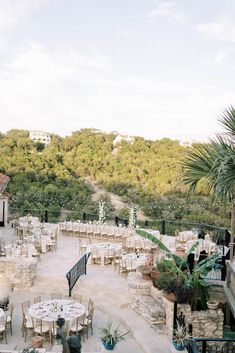 an outdoor dining area with tables and chairs set up for guests to enjoy the view