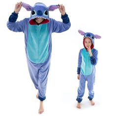 two children dressed in pajamas and onesuits, one with a shark costume on