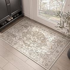 a large area rug in the corner of a room next to a cabinet and window