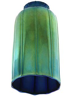 a green and blue vase sitting on top of a table