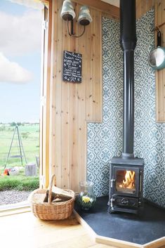 a wood burning stove sitting inside of a kitchen