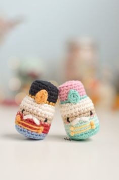 two small crocheted toys sitting next to each other