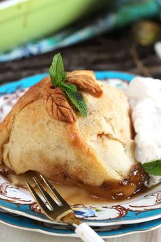 a piece of pie on a plate with ice cream and mint garnishes