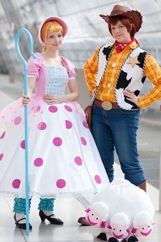 two children dressed up as toy story book characters, one holding a broom and the other standing next to her