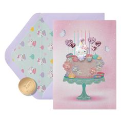 a card with a hello kitty on top of it and a gold coin next to it