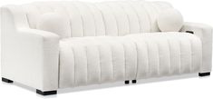 a white couch sitting on top of a wooden table