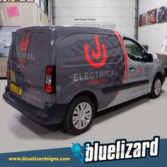 an electrician van parked in a garage with the word electrical painted on it's side