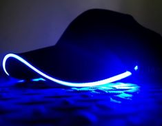 a black hat is lit up with blue light