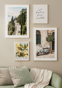 a living room with pictures on the wall and a green couch in front of it