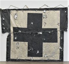 a black and white quilt hanging on the wall