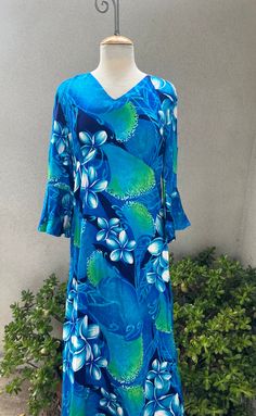 Vintage Hawaiian luau maxi dress green blues floral Sz M by Sears Hawaiian Fashions. Made in USA of possible acetate fabric. Back zipper and keyhole cutout in sleeves. Good condition  Measurements  Shoulder 16" Bell sleeves 19" Bust 42" Waist 36" Hips 46" Length 54" Blue Hawaiian V-neck Dress, Blue Hawaiian Dress With Tropical Print, Blue V-neck Hawaiian Dress, Green Hawaiian Floral Print Dress, Blue Tropical Dress With Hibiscus Print, Green Hawaiian Maxi Dress For Spring, Flowy Blue Tropical Print Dress, Blue Fitted Hawaiian Dress, Blue Hawaiian Maxi Dress With Floral Print