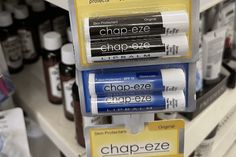 three batteries are stacked on top of each other in a store display case with labels that read chap - eze