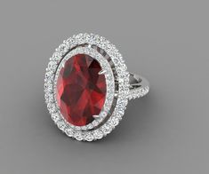 a ring with a large red stone surrounded by small white diamonds on the sides and an oval