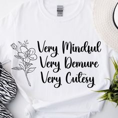 Show off your TikTok vibes with our "Very Mindful, Very Demure, Very Cutesy" T-Shirt! This trendy design captures the essence of your favorite TikTok personalities, blending mindfulness, elegance, and cuteness into one stylish statement. The unisex soft-style t-shirt puts a new spin on casual comfort. Made from very soft materials, this tee is 100% cotton for solid colors. Heather colors and sports grey include polyester. The shoulders have twill tape for improved durability. There are no side seams. The collar is made with ribbed knitting to prevent curling damage.  .: Made with 100% ring-spun cotton, a lightweight fabric (4.5 oz/yd² (153 g/m this unisex t-shirt feels like a bliss to wear all year round.  .: The classic fit with the crew neckline deliver a clean, versatile style that can White Quote Print T-shirt For Summer, Trendy Cotton T-shirt With Quote Print, White Graphic Tee With Quote Print, White Cotton Tops With Quote Print, Cotton Tops With Quote Print For Spring, White Cotton Top With Quote Print, Spring Cotton Tops With Quote Print, White Summer T-shirt With Quote Print, Trendy Relaxed Fit Top With Quote Print