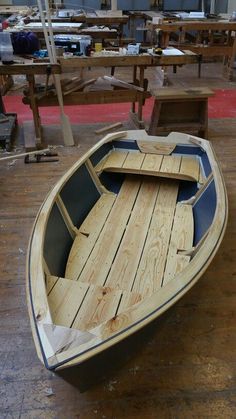 a wooden boat sitting on top of a wooden floor