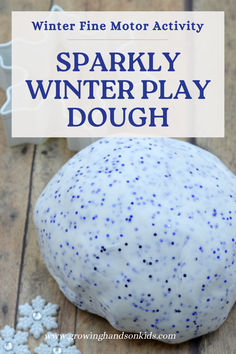 A close-up of sparkly white play dough with blue glitter, designed as a winter fine motor activity. The play dough sits on a wooden surface alongside decorative snowflake embellishments and white cookie cutters in the background. The text overlay reads, "Winter Fine Motor Activity - Sparkly Winter Play Dough." Schnee Party, Play Dough Recipe, Melting Snowman, Winter Activities Preschool, January Crafts, Winter Play, Eyfs Activities, Winter Classroom, Winter Activities For Kids