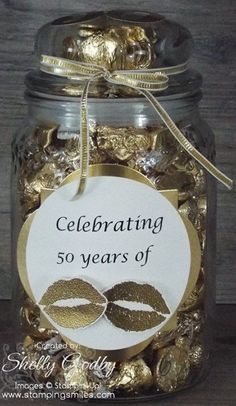 a jar filled with gold foiled chocolates and a label that says celebrating 50 years of