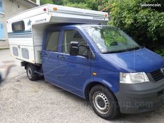 a blue van parked in front of a house