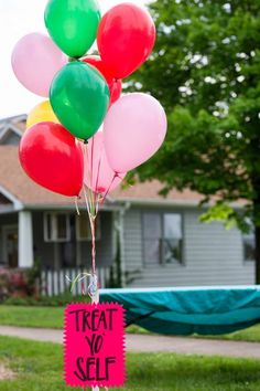 there is a sign that says treat yo self with balloons in front of a house