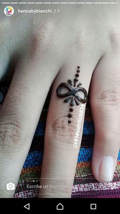 a person's hand with a tattoo on it