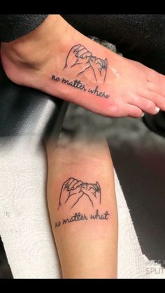 two people with matching tattoos on their feet, one is holding the other's hand