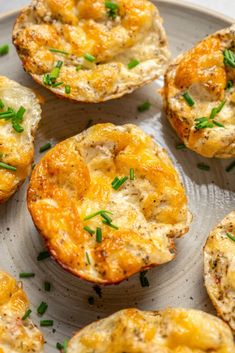 several small muffins on a plate with green garnish