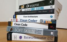 a stack of books sitting on top of a wooden table