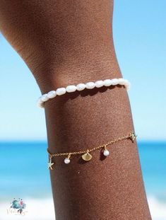 If you love the ocean as much as we do, you will fall in love with our Kula Kabana beachy bracelet. Decorated with shells, starfish and freshwater pearls this bracelet will remind you of the ocean where ever you go Our delicate yet detailed ocean inspired bracelet is truly made for mermaids. Never worry about taking it off with our 18k gold & sterling silver water safe jewelry Made with sterling silver & 18k gold vermeil - will never turn your skin green or tarnish Made with real ethically sourc Bracelet Ocean, Beachy Bracelets, Made For Mermaids, Shell Jewellery, Pearl Charm Bracelet, Freshwater Pearl Bracelet, Ocean Inspired, Summer Essential, Shell Jewelry