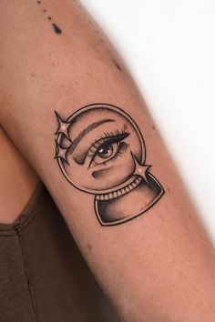 a woman's arm with a black and white drawing of an eye on it