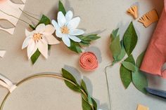 some paper flowers and scissors on a table